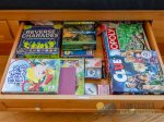 The window seat has storage full of games.